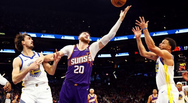 Dec 12, 2023; Phoenix, Arizona, USA; Phoenix Suns center Jusuf Nurkic (20) yes for a rebound against Golden State Warriors forward Dario Saric (20) and guard Stephen Curry (30) during the first quarter at Footprint Center. Mandatory Credit: Mark J. Rebilas-USA TODAY Sports Photo: Mark J. Rebilas/REUTERS