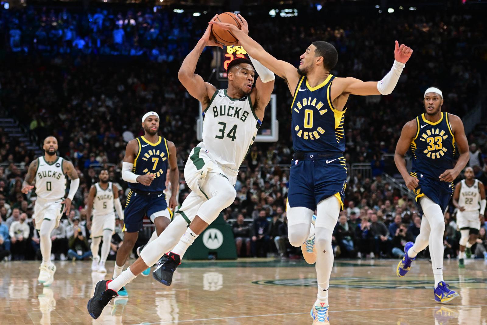 Dec 13, 2023; Milwaukee, Wisconsin, USA; Milwaukee Bucks forward Giannis Antetokounmpo (34) drives for the basket against Indiana Pacers guard Tyrese Haliburton (0) in the fourth quarter at Fiserv Forum. Mandatory Credit: Benny Sieu-USA TODAY Sports Photo: Benny Sieu/REUTERS