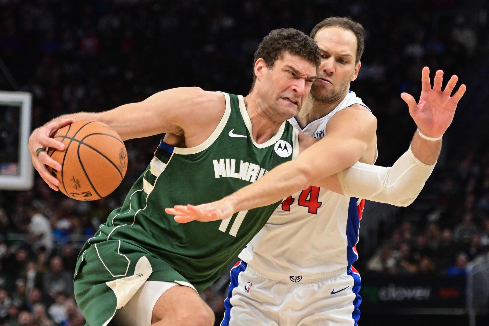 Dec 16, 2023; Milwaukee, Wisconsin, USA; Milwaukee Bucks center Brook Lopez (11) drives for the basket against Detroit Pistons forward Bojan Bogdanovic (44) in the third quarter at Fiserv Forum. Mandatory Credit: Benny Sieu-USA TODAY Sports Photo: Benny Sieu/REUTERS
