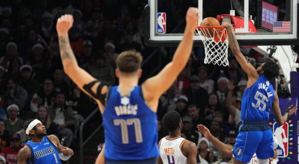 Dec 25, 2023; Phoenix, Arizona, USA; Dallas Mavericks guard Luka Doncic (77) celebrates as Dallas Mavericks forward Derrick Jones Jr. (55) dunks against the Phoenix Suns during the first half at Footprint Center. Mandatory Credit: Joe Camporeale-USA TODAY Sports Photo: Joe Camporeale/REUTERS