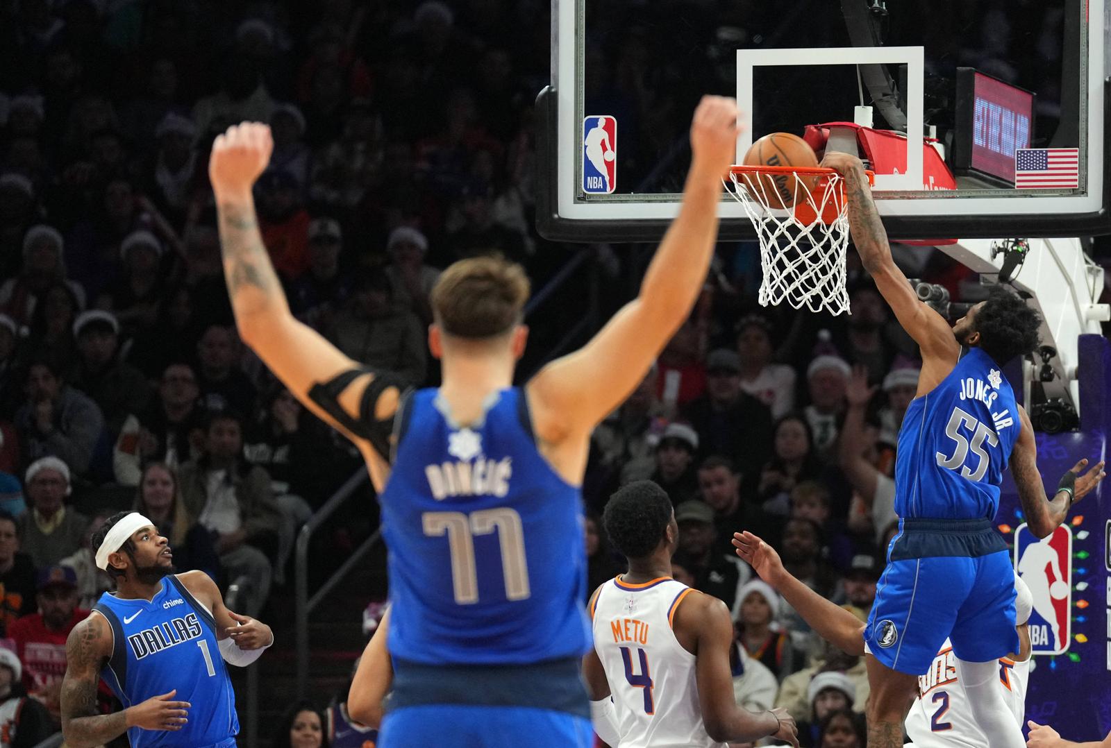Dec 25, 2023; Phoenix, Arizona, USA; Dallas Mavericks guard Luka Doncic (77) celebrates as Dallas Mavericks forward Derrick Jones Jr. (55) dunks against the Phoenix Suns during the first half at Footprint Center. Mandatory Credit: Joe Camporeale-USA TODAY Sports Photo: Joe Camporeale/REUTERS