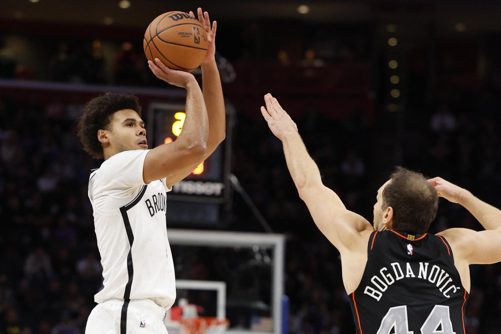 Dec 26, 2023; Detroit, Michigan, USA; Brooklyn Nets forward Cameron Johnson (2) puts up a shot over Detroit Pistons forward Bojan Bogdanovic (44) in the second half at Little Caesars Arena. Mandatory Credit: Rick Osentoski-USA TODAY Sports Photo: Rick Osentoski/REUTERS