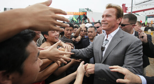 Gov. Arnold Schwarzenegger greets workers during his visit to Zhenhua Port Machinery Company (ZPMC) Monday, Sept. 13, 2010 in Shanghai. ZPMC is building the new east span of San Franciscos Oakland Bay Bridge. (AP Photo/Eugene Hoshiko)