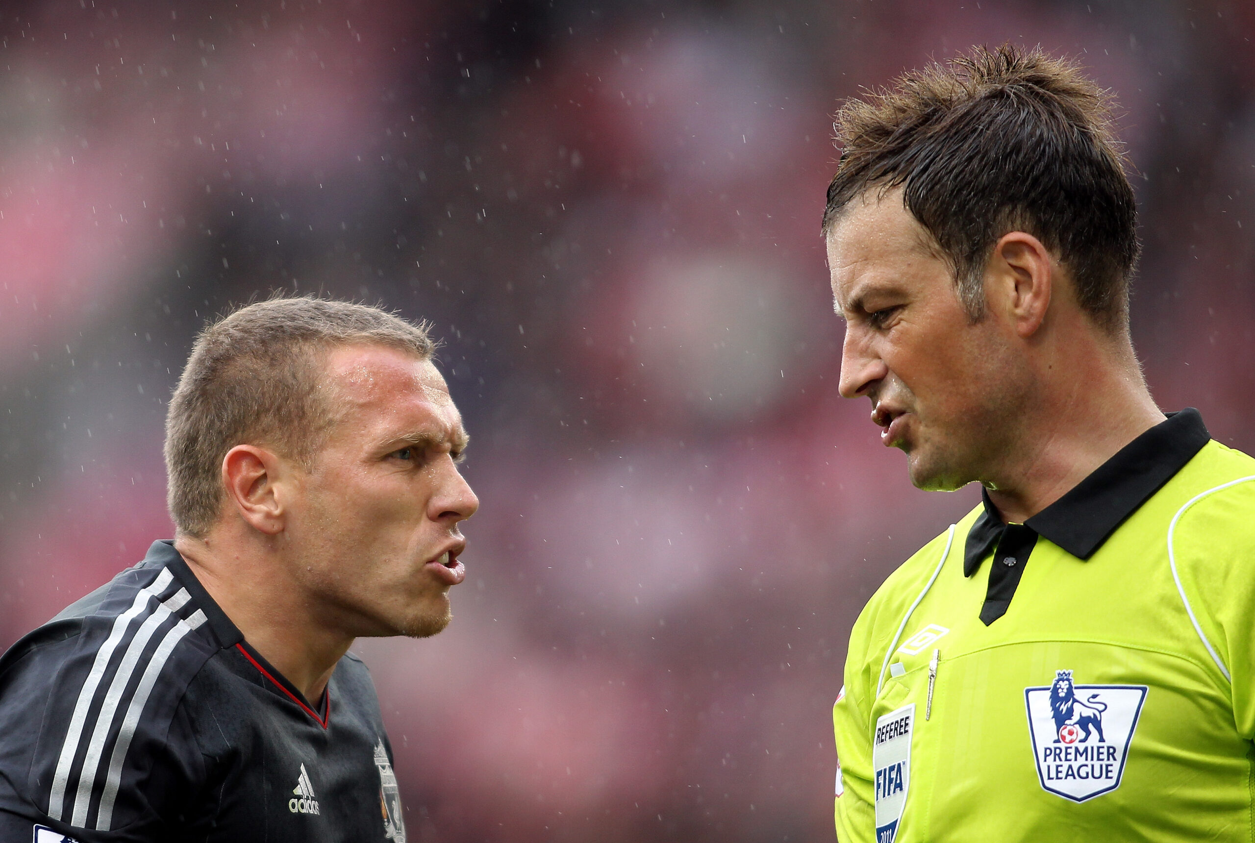 Liverpool's Craig Bellamy, left, reacts to referee Mark Clattenburg during their English Premier League soccer match at the Britannia stadium, Stoke, England. Saturday, Sept. 10, 2011. (AP Photo/Simon Dawson)