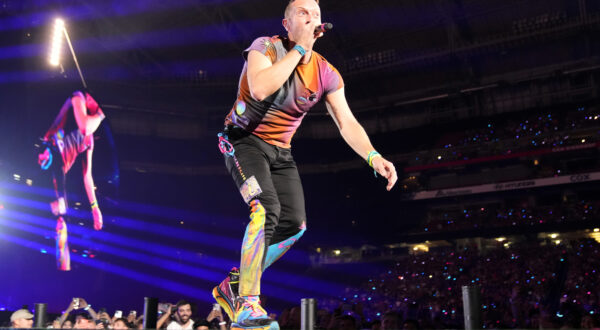 Chris Martin of Coldplay performs during the band's Music of the Spheres world tour on Thursday, May 12, 2022, at State Farm Stadium in Glendale, Ariz. (Photo by Rick Scuteri/Invision/AP)