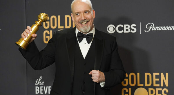 Paul Giamatti poses in the press room with the award for best performance by an actor in a motion picture, musical or comedy for "The Holdovers" at the 81st Golden Globe Awards on Sunday, Jan. 7, 2024, at the Beverly Hilton in Beverly Hills, Calif. (AP Photo/Chris Pizzello)