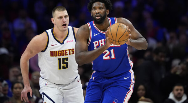 Philadelphia 76ers' Joel Embiid, right, tries to keep away from Denver Nuggets' Nikola Jokic during the first half of an NBA basketball game, Tuesday, Jan. 16, 2024, in Philadelphia. (AP Photo/Matt Slocum)