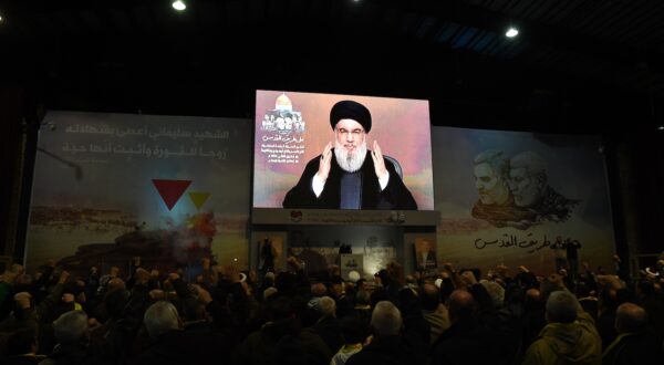 epa11055541 People watch a televised speech of Hezbollah secretary general Hasan Nasrallah, during an event to mark the fourth anniversary of top Iranian commander Qasem Soleimani death, in southern suburb of Beirut, Lebanon, 03 January 2024.  EPA/ABBAS SALMAN