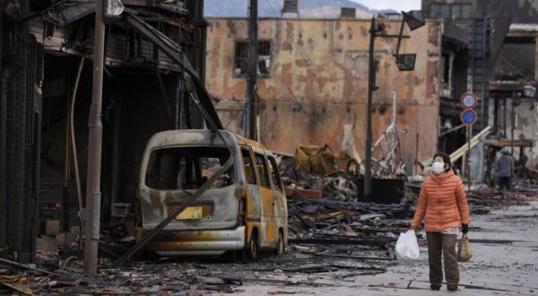epa11056363 A woman looks at the burnt remains of a vehicle and building structures following an earthquake in Wajima, Ishikawa Prefecture, Japan, 04 January 2024. The Ishikawa Prefecture Government announced that 78 people were killed and 25 missing following a magnitude 7 earthquake (the USGS listed the earthquake as 7.5 magnitude) which occurred on 01 January. About 33,000 residents in Ishikawa Prefecture have evacuated to 355 makeshift evacuation centers. According to Hokuriku Electric Power Company, about 33,900 homes lost electricity in the prefecture.  EPA/FRANCK ROBICHON