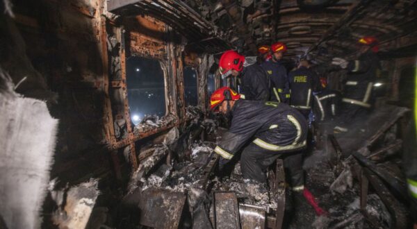 epa11059401 Bangladeshi Firefighters work at the scene of a fire in a passenger train, ahead of general election in Dhaka, Bangladesh, 05 January, 2024. According the Bangladeshi Fire Service and Civil Defence, at least four passengers were killed and several others are injured as Benapole Express was set on fire in the capital's Gopibagh area in Dhaka.  EPA/MONIRUL ALAM