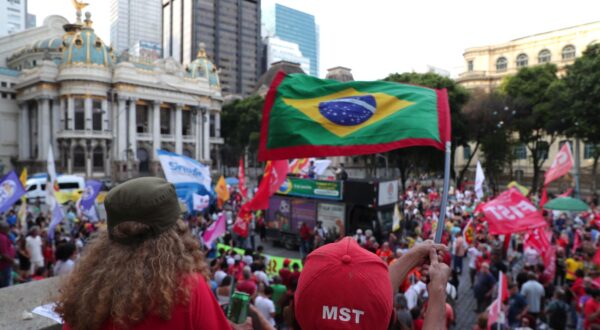epa11065069 People hold placards and flags as they gather to mark the first anniversary of the failed coup attempt by extreme right in Cinelandia, in Rio de Janeiro, Brazil, 08 January 2024. On the day of 08 January 2023 followers of former president Jair Bolsonaro, who did not accept the defeat of the far-right at the polls, destroyed the headquarters of Congress, the Supreme Court of Justice and the Planalto Presidential Palace. Brazilian President Luiz Inacio Lula da Silva said on 08 January during the act of defense of democracy after a year of the uprising by far-right extremists, that all those who financed the coup attempt must be 'exemplarily punished'.  EPA/Andre Coelho