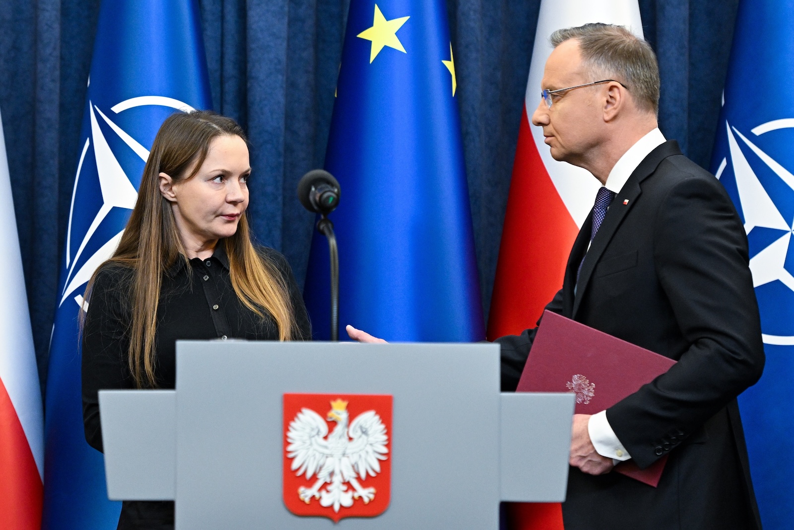epa11069559 President of Poland Andrzej Duda (R) and Mariusz Kaminski's wife Barbara Kaminska (L) during a statement at the Presidential Palace in Warsaw, Poland, 11 January 2024. The president announced that he had initiated pardon proceedings against Mariusz Kaminski and Maciej Wasik. The former head of the CBA and former interior minister and his former deputy in December 2023 were sentenced to two years in prison for abuse of power when they led an anti-corruption office in 2007.  EPA/Radek Pietruszka  POLAND OUT
