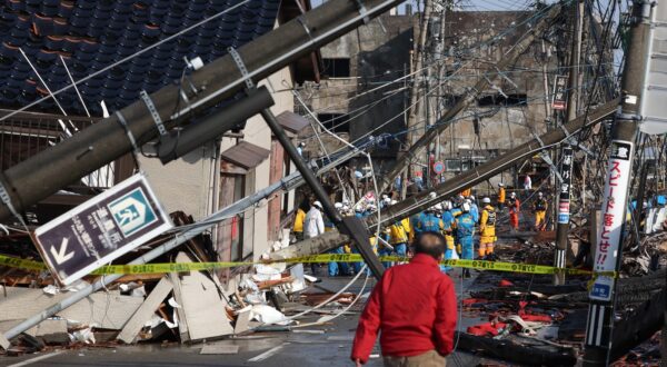 epa11070688 Police forces work in a burned down morning market following a powerful earthquake that hit the region, in Wajima, Ishikawa Prefecture, Japan, 12 January 2024. According to data by the Ishikawa Prefecture Government, at least 215 people were killed, and 38 are missing following a magnitude 7.6 earthquake on 01 January. About 26,000 residents in Ishikawa Prefecture have evacuated to 390 makeshift evacuation centers.  EPA/JIJI PRESS JAPAN OUT EDITORIAL USE ONLY