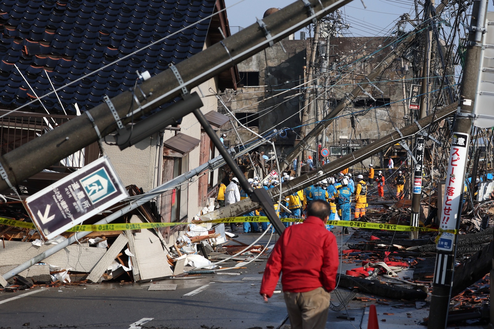 epa11070688 Police forces work in a burned down morning market following a powerful earthquake that hit the region, in Wajima, Ishikawa Prefecture, Japan, 12 January 2024. According to data by the Ishikawa Prefecture Government, at least 215 people were killed, and 38 are missing following a magnitude 7.6 earthquake on 01 January. About 26,000 residents in Ishikawa Prefecture have evacuated to 390 makeshift evacuation centers.  EPA/JIJI PRESS JAPAN OUT EDITORIAL USE ONLY