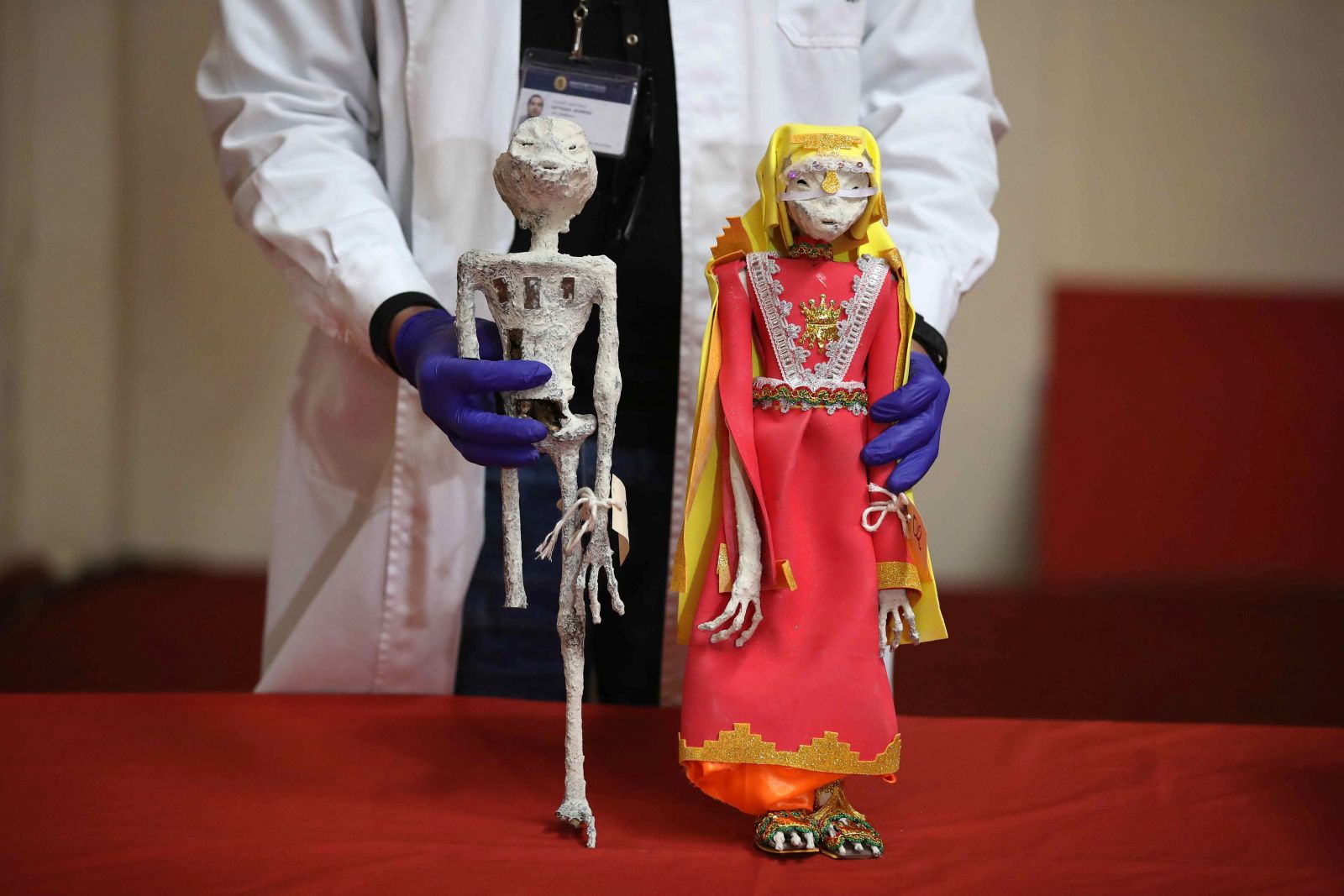 epaselect epa11072447 Two pieces that look like small mummies that were seized in October 2023 at the Lima airport and that were going to be sent to Mexico, are presented at a press conference by the Ministry of Culture of Peru with the results of an expert opinion, in Lima, Peru, 12 January 2024. Different experts from the Ministry of Culture and the Peruvian Prosecutor's Office described as 'fraud' some alleged extraterrestrial mummies very similar to those presented by the 'ufologist' Jaime Maussan. The two dolls were found in a box in a warehouse of an international logistics company in a Lima province.  EPA/Paolo Aguilar