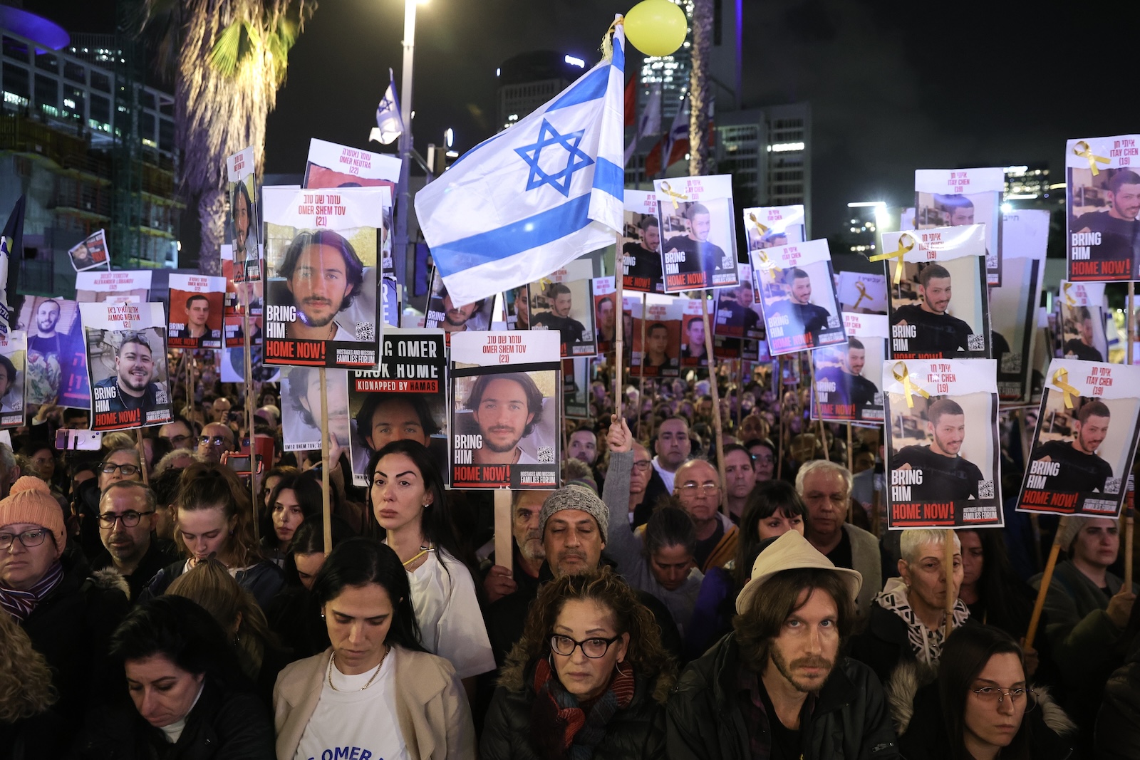 epa11074641 Supporters and families hold pictures of hostages held by Hamas in Gaza as they take part in a '100 Days of Hell' rally calling for their immediate release and marking the upcoming 100th day of their captivity, outside the Kirya military base in Tel Aviv, Israel, 13 January 2024. According to the Israeli government, 136 Israelis are still being held hostage by Hamas in the Gaza Strip. According to organizers, some 120,000 people attended the rally to mark the upcoming one-hundredth day, on 14 January 2024, since the 07 October Hamas attack on Israel. More than 23,600 Palestinians and at least 1,300 Israelis have been killed, according to the Palestinian Health Ministry and the Israel Defense Forces (IDF), since Hamas militants launched an attack against Israel from the Gaza Strip on 07 October, and the Israeli operations in Gaza and the West Bank which followed it.  EPA/ABIR SULTAN