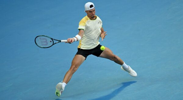 epa11075552 Dino Prizmic of Croatia returns during his first round match against  Novak Djokovic of Serbia on Day 1 of the 2024 Australian Open at Melbourne Park in Melbourne, Australia, 14 January 2024.  EPA/LUKAS COCH AUSTRALIA AND NEW ZEALAND OUT