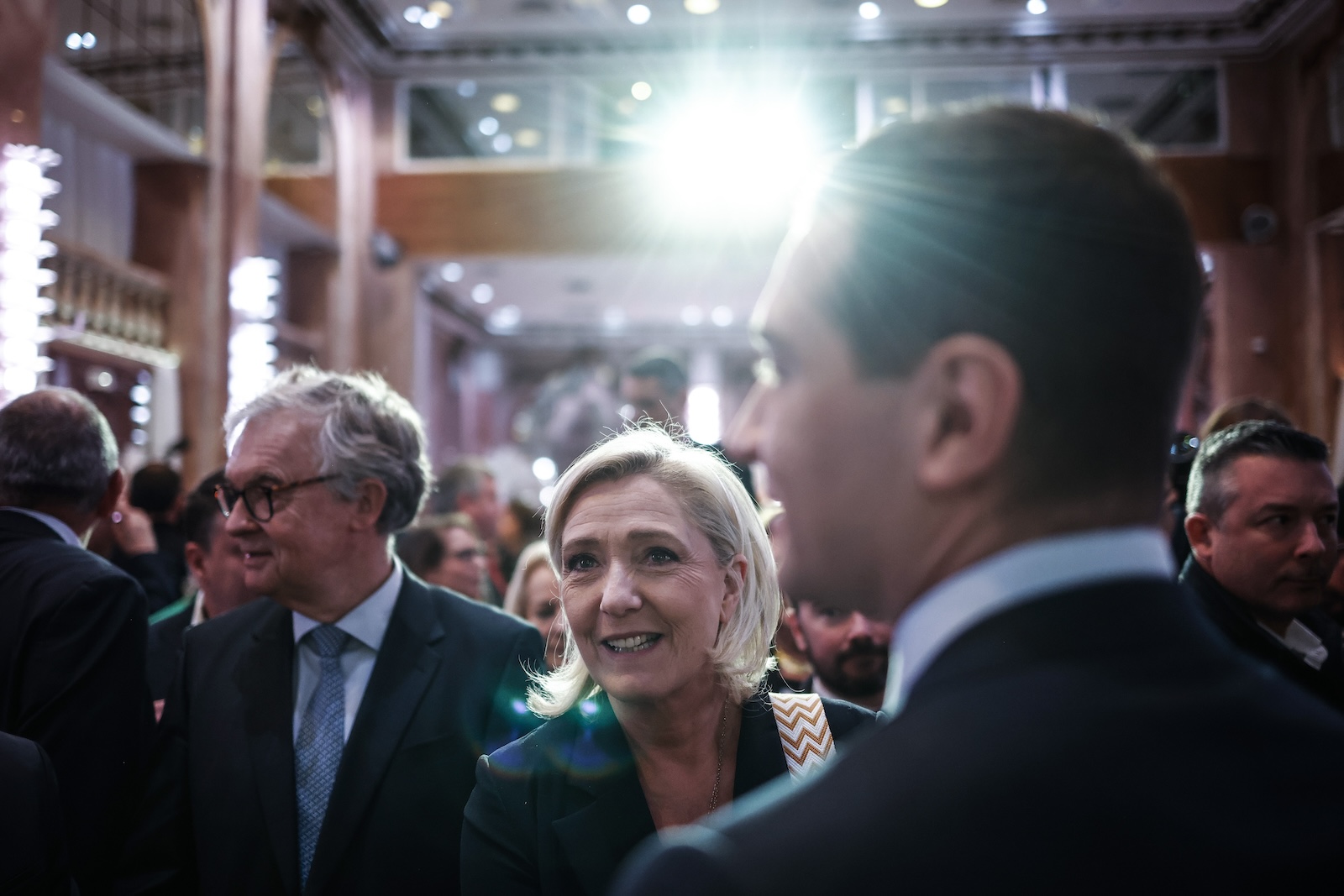 epa11079290 French member of Parliament for far-right Rassemblement National (RN) party Marine Le Pen (C) looks on after French far-right party Rassemblement National (RN) president Jordan Bardella (R) delivered his speech, during a conference to present his Best Wishes 2024 to the Press, at Salons Hoche in Paris, France, 15 January 2024.  EPA/YOAN VALAT