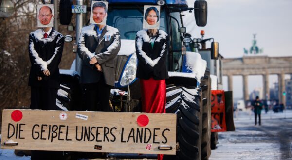 epa11087923 A tractor is decorated with mannequins with photos of German Chancellor Olaf Scholz (L), German Minister for Economy and Climate Robert Habeck (C) and German Foreign Minister Annalena Baerbock (R) during a protest of truckers in Berlin, Germany, 18 January 2024. The wooden board reads 'The scourge of our country.' Farmers in Germany went on a nationwide strike to protest the federal government's agricultural policies. Later, truckers joined the recent protests in support of the farmers.  EPA/CLEMENS BILAN