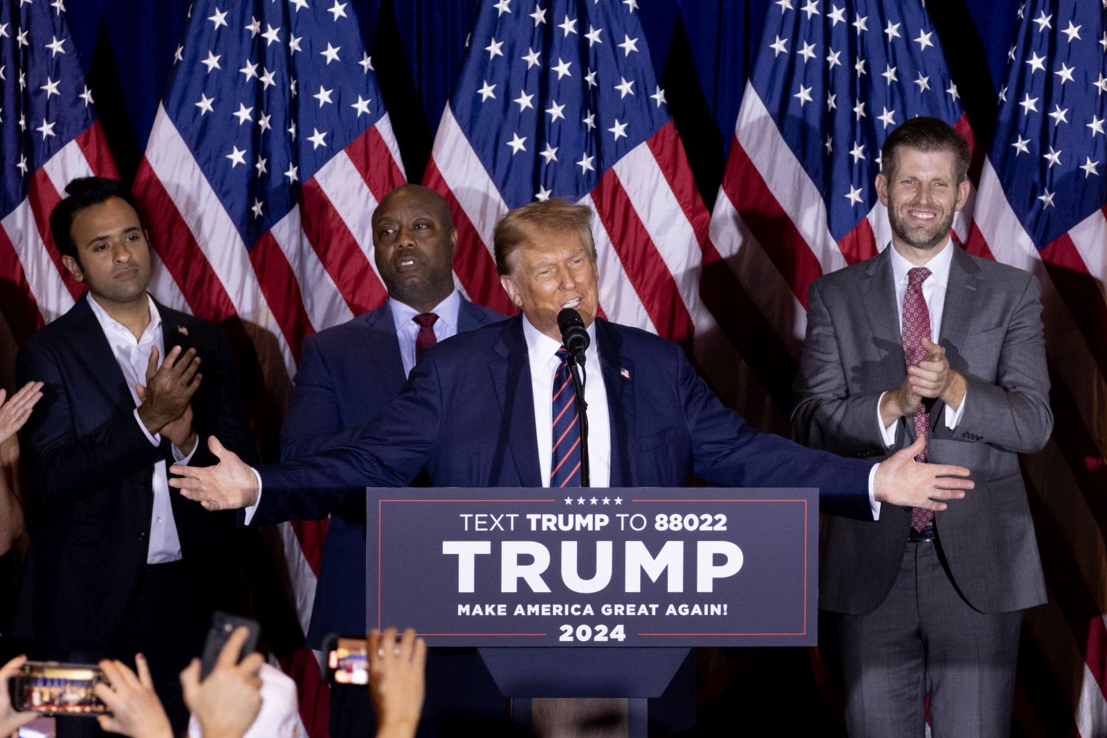 epa11099990 Former US President Donald J. Trump delivers a speech after winning the New Hampshire primary, during an election night watch party in Nashua, New Hampshire, USA, 23 January 2024. The New Hampshire primary is the first primary in the nation and the second contest in the nominating process for the Republican presidential nomination. In the backround (L-R) former Republican presidential candidate Vivek Ramaswamy, Republican Senator of South Carolina Tim Scott and Eric Trump.  EPA/MICHAEL REYNOLDS