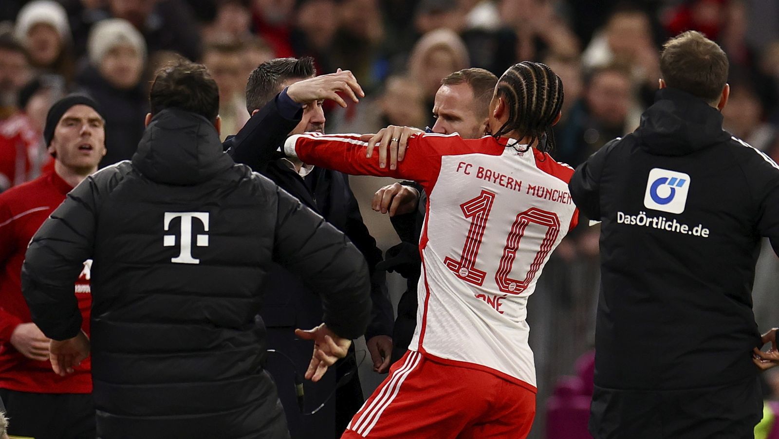 epa11102171 Munich's Leroy Sane (R) and Union’s head coach Nenad Bjelica (L) interact during the German Bundesliga soccer match between FC Bayern Munich and Union Berlin in Munich, Germany, 24 January 2024.  EPA/ANNA SZILAGYI CONDITIONS - ATTENTION: The DFL regulations prohibit any use of photographs as image sequences and/or quasi-video.