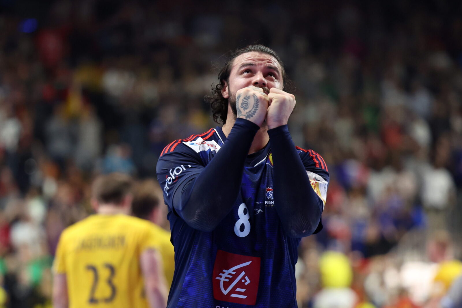 epa11106724 France's Elohim Prandi reacts after winning  the EHF Men's EURO 2024 semi final handball match between France and Sweden in Cologne, Germany, 26 January 2024.  EPA/CHRISTOPHER NEUNDORF