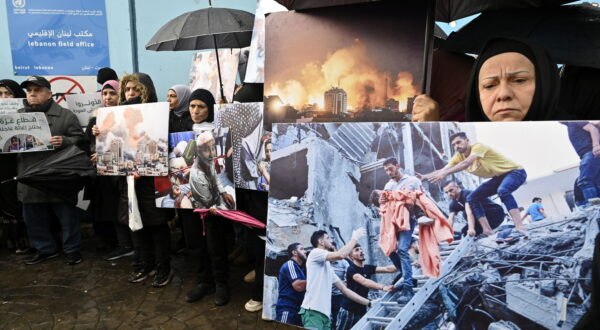 epa11113803 Palestinian residents in Lebanon carry pictures during a protest against the decision of numerous donor countries to cease funding UNRWA outside UNRWA offices in Beirut, Lebanon, 30 January 2024. Several Western countries along with the USA, Canada and Australia, the United Kingdom, Germany, Italy, the Netherlands, Switzerland, Finland, and Austria have suspended or reviewed funding to the UN agency for Palestinians following Israel's allegations that some UNRWA staff members had been involved in the 07 October 2023 Hamas attacks.  EPA/WAEL HAMZEH