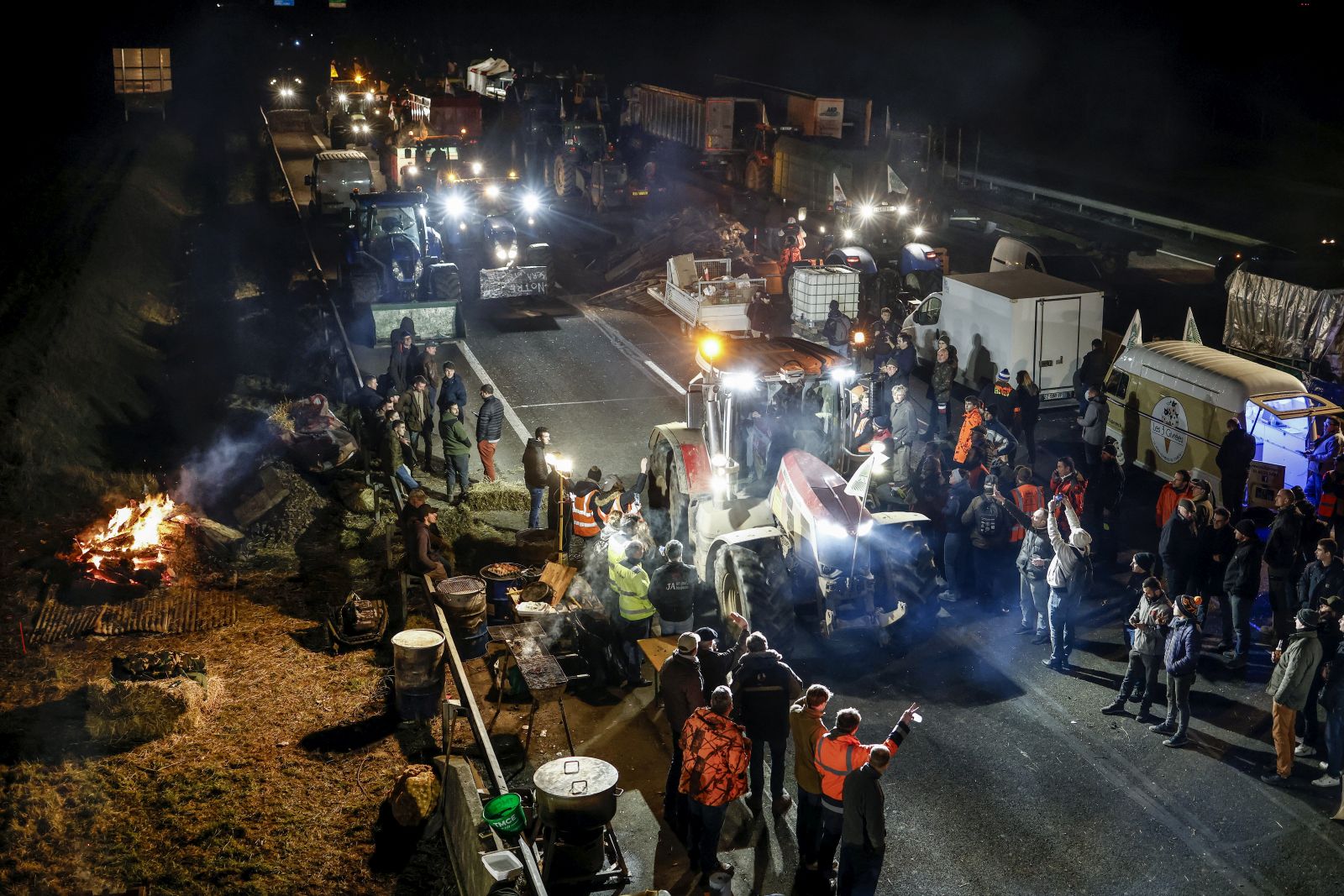 epa11114548 Dozens of French farmers arriving by truck join the blockade point on the A4 motorway at Jossigny, east of Paris, France, 30 January 2024. French farmers continue their protests with road blockades and demonstrations in front of state buildings awaiting a response from the government to their request for 'immediate' aid of several hundred million euros. On 23 January, the EU Agriculture and Fisheries Council highlighted the importance of providing the conditions necessary to enable EU farmers to ensure food security sustainably and profitably, as well as ensuring a fair income for farmers.  EPA/YOAN VALAT