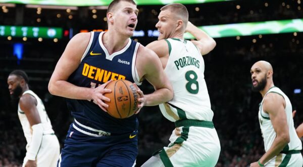 Jan 19, 2024; Boston, Massachusetts, USA; Denver Nuggets center Nikola Jokic (15) moves the ball against Boston Celtics center Kristaps Porzingis (8) in the first quarter at TD Garden. Mandatory Credit: David Butler II-USA TODAY Sports Photo: David Butler II/REUTERS