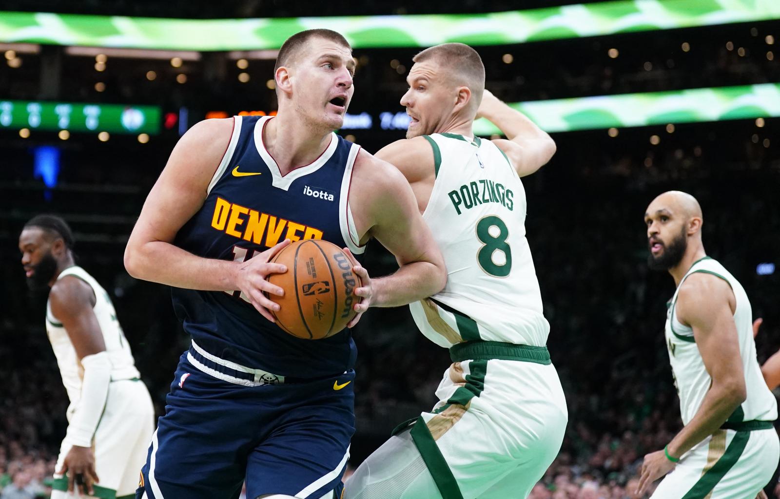 Jan 19, 2024; Boston, Massachusetts, USA; Denver Nuggets center Nikola Jokic (15) moves the ball against Boston Celtics center Kristaps Porzingis (8) in the first quarter at TD Garden. Mandatory Credit: David Butler II-USA TODAY Sports Photo: David Butler II/REUTERS