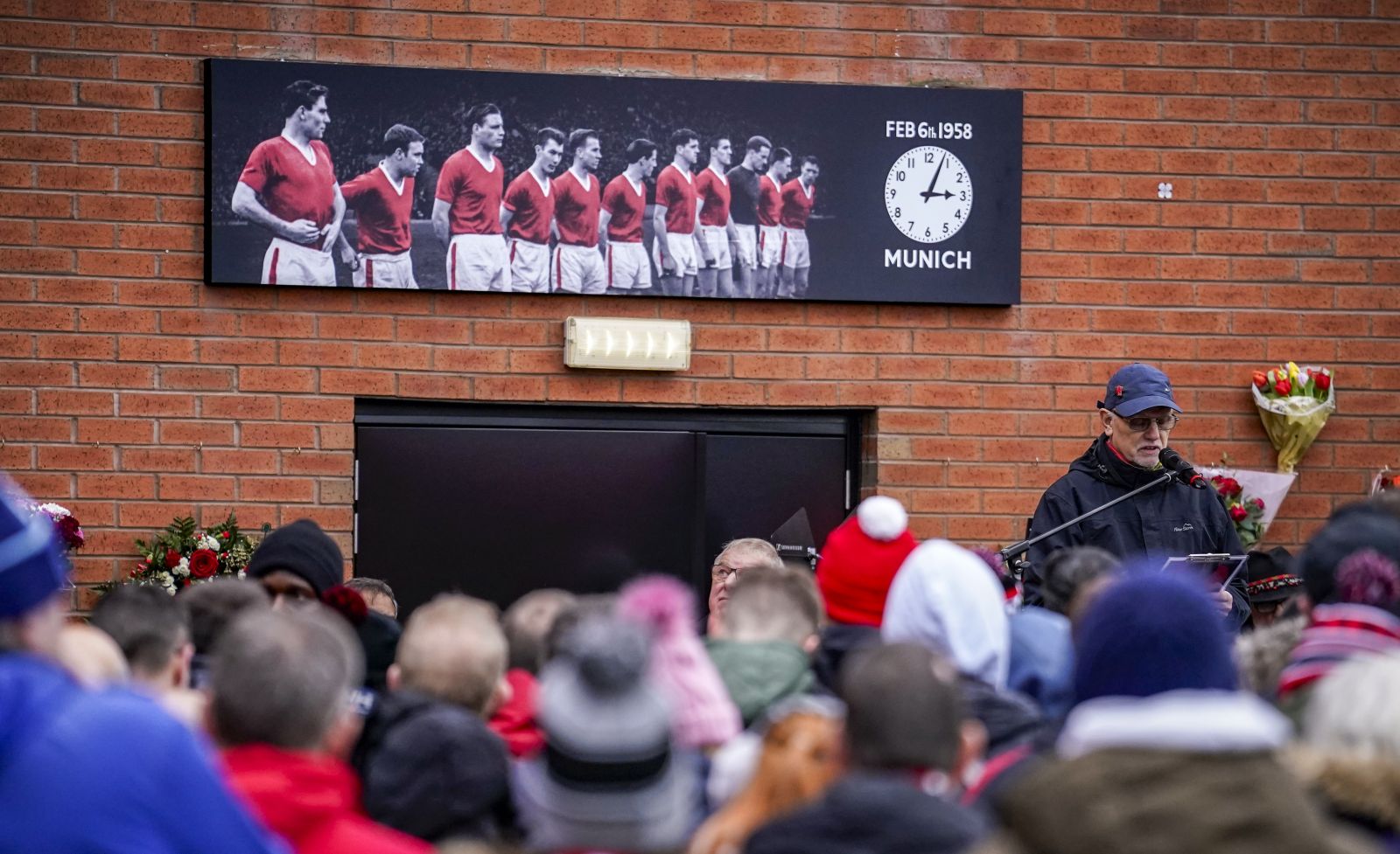 People gather outside the stadium during a commemoration of the Feb. 6,1958, Munich air disaster before the English Premier League soccer match between Manchester United and West Ham at the Old Trafford in Manchester, England, Sunday, Feb. 4, 2024. On board the crashed plane was the Manchester United football team, nicknamed the Busby Babes, along with supporters and journalists. Twenty-three of the 44 passengers on board the aircraft died in the crash. (AP Photo/Dave Thompson)