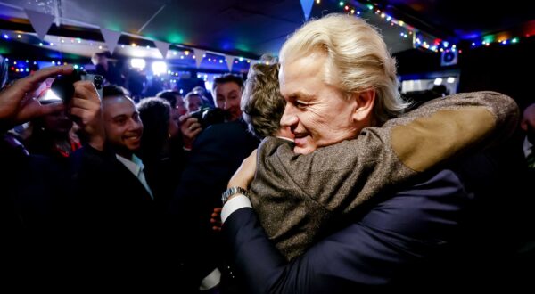 epa10990069 PVV leader Geert Wilders (R) is hugged as he responds to the results of the House of Representatives elections in Scheveningen, Netherlands, 22 November 2023. Dutch voters headed to the polls on 22 November to elect the members of the House of Representatives and a new prime minister, after Netherlands' longest-serving prime minister, Mark Rutte's cabinet collapsed in July.  EPA/REMKO DE WAAL