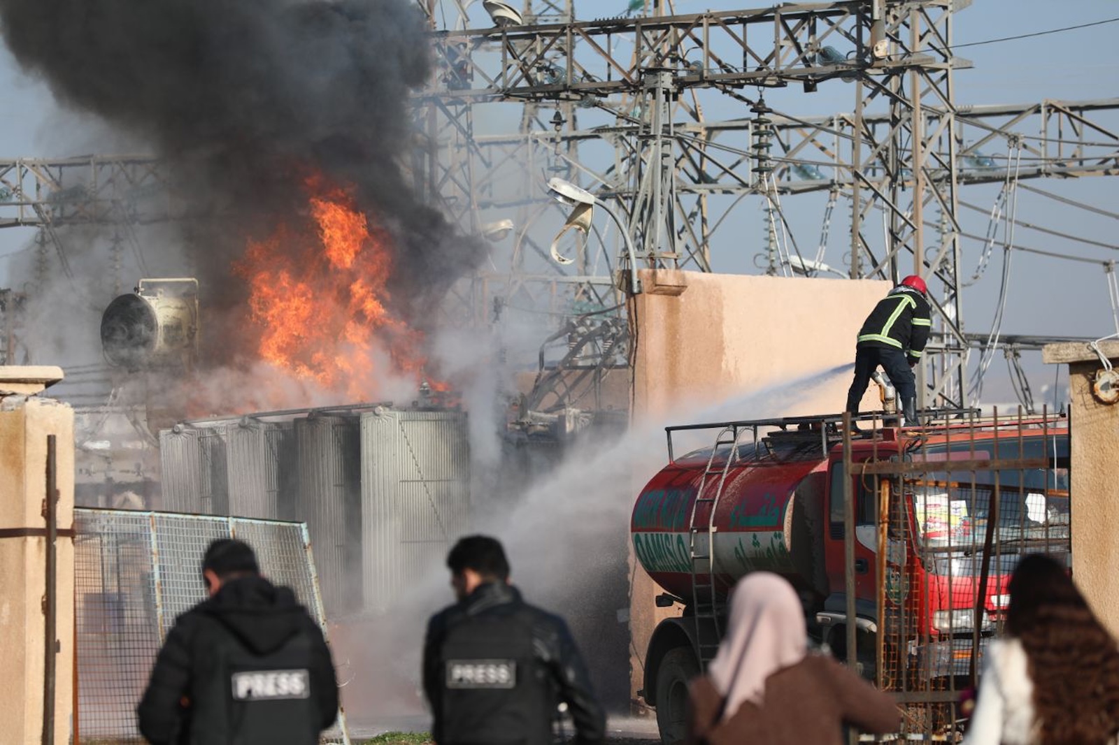 epa11079611 Firefighters try to extinguish flames at a power station in Qamishli town, northeast Syria, 15 January 2024. Syrian state-media said Turkish drone targeted locations in northern Syria, adding that transformer stations in Qamishli went out of service. Turkey on 14 January announced targeting Kurdish sites in northern Iraq and Syria they suspect to have links to the Kurdistan Workers Party (PKK), after the death of nine Turkish soldiers in an attack in northern Iraq.  EPA/AHMED MARDNLI