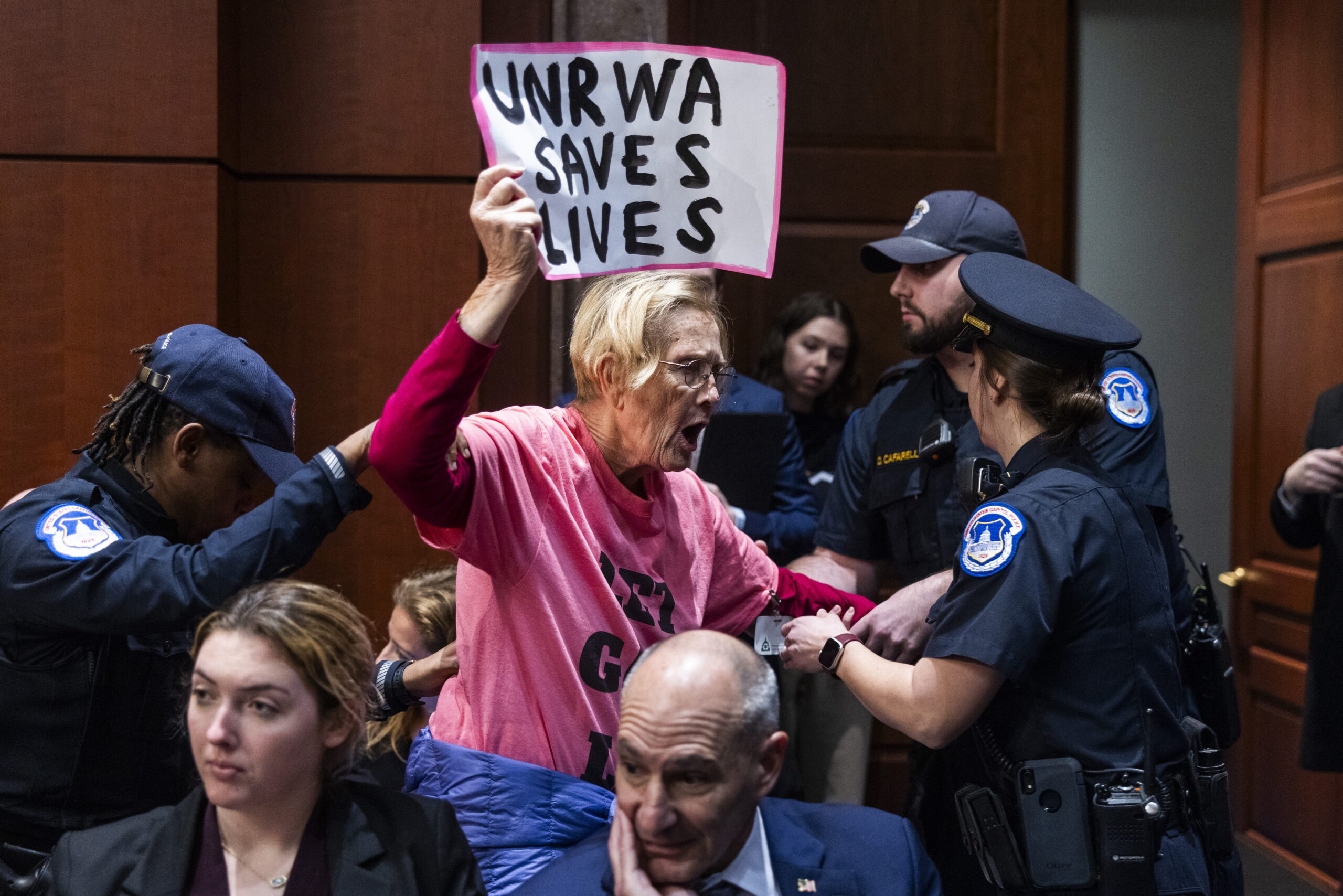 epa11114664 Capitol police remove a Pro-Palestinian protester who interrupted a House Committee on Foreign Affairs' Subcommittee on Oversight and Accountability hearing on the United Nations Relief and Works Agency (UNRWA) for Palestine Refugees in the US Capitol in Washington, DC, USA, 30 January 2024. Israel has accused at least 12 UN workers of participating in Hamas's 07 October attack on Israel.  EPA/JIM LO SCALZO