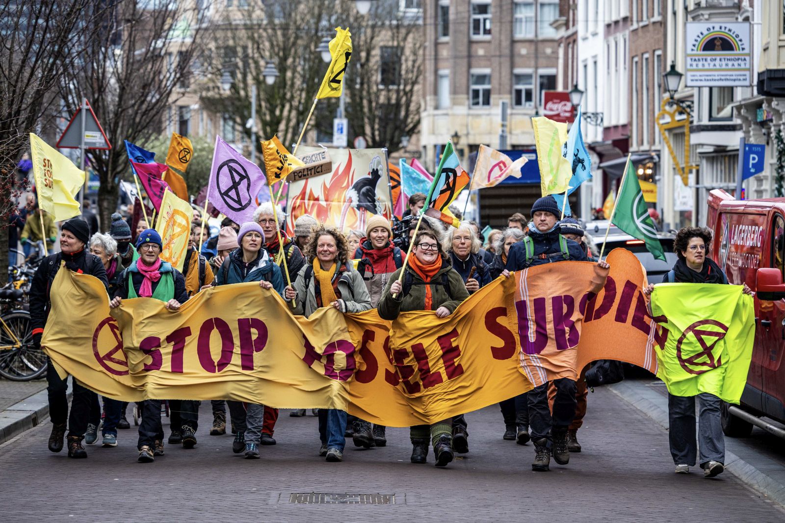 epa11122901 Climate activists from the Extinction Rebellion (XR) carry a banner as they stage a blockade on the Utrechtsebaan, a section of the A12 motorway, to demand an end to fossil fuel subsidies in The Hague, the Netherlands, 03 February 2024.  EPA/RAMON VAN FLYMEN