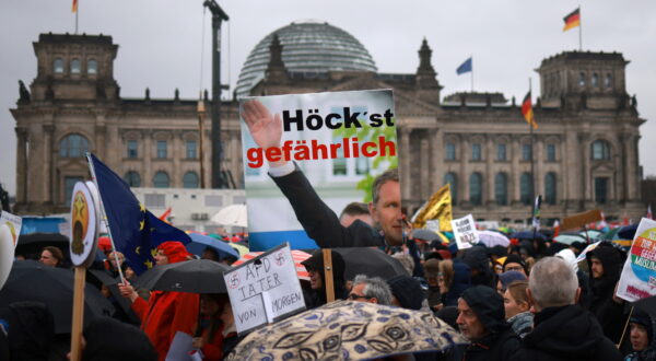 epa11123418 A participant holds a placard referring to Alternative for Germany party (AfD) faction chairman in the regional parliament of Thuringia, Bjoern Hoecke, with a play on words incorporating Hoecke’s last name, reading ‘highly dangerous’ during a demonstration against a swing to the political right and right-wing extremism in front of the Reichstag building, the seat of the German parliament, in Berlin, Germany, 03 February 2024. The large-scale demonstration against right-wing normalization in Germany and Europe takes place under the motto 'We are the firewall! (Wir sind die Brandmauer!).  EPA/CLEMENS BILAN