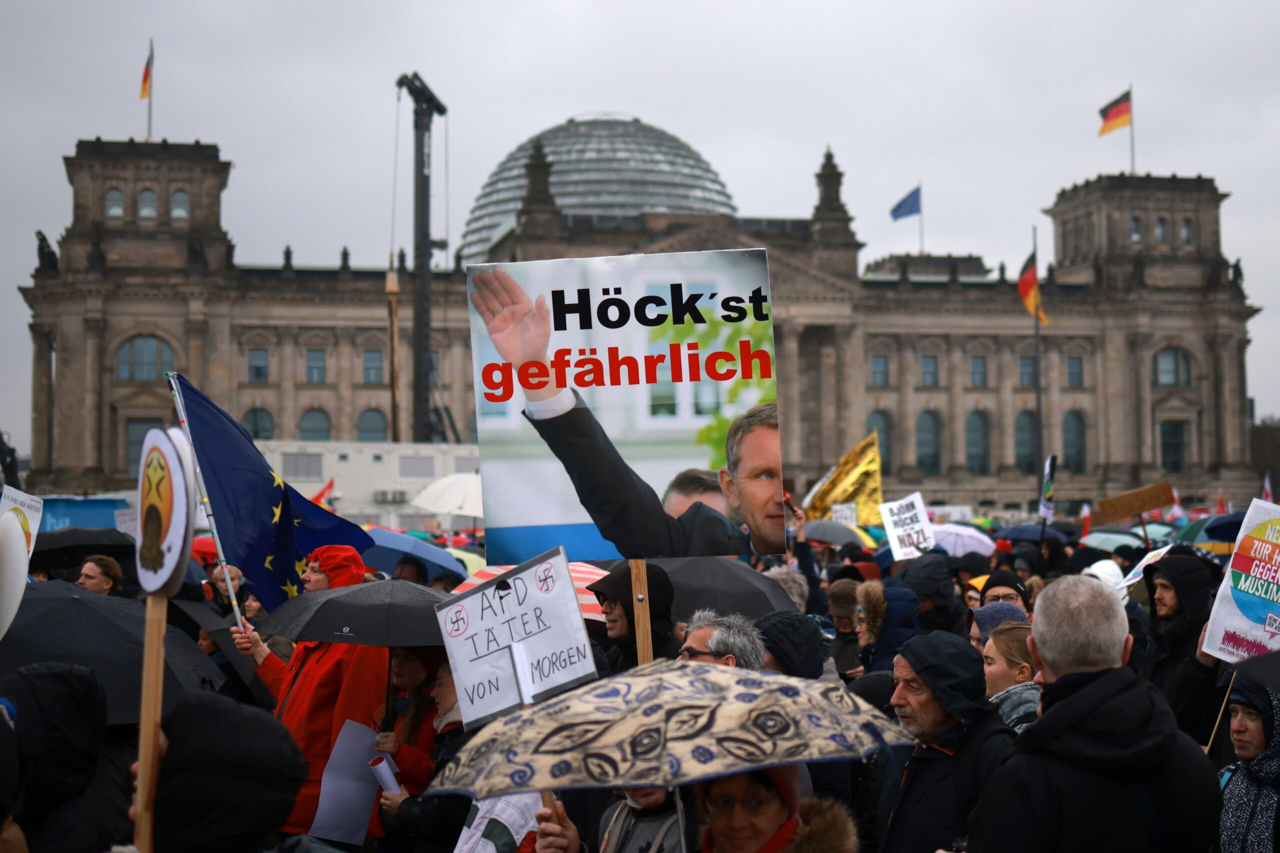 epa11123418 A participant holds a placard referring to Alternative for Germany party (AfD) faction chairman in the regional parliament of Thuringia, Bjoern Hoecke, with a play on words incorporating Hoecke’s last name, reading ‘highly dangerous’ during a demonstration against a swing to the political right and right-wing extremism in front of the Reichstag building, the seat of the German parliament, in Berlin, Germany, 03 February 2024. The large-scale demonstration against right-wing normalization in Germany and Europe takes place under the motto 'We are the firewall! (Wir sind die Brandmauer!).  EPA/CLEMENS BILAN