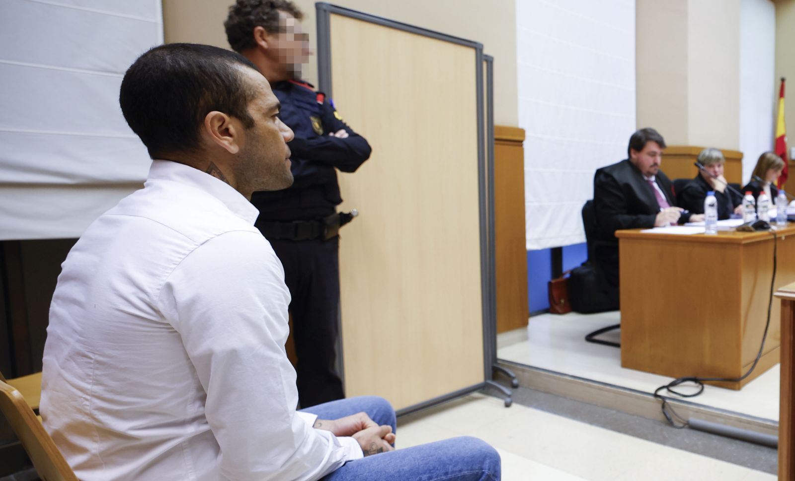 epa11128578 Brazilian soccer player Dani Alves (L) sits on the dock during his trial for alleged sexual assault at Barcelona's Court in Barcelona, Spain, 05 February 2024. Alves is accused of sexually assaulting a woman inside a bathroom at a disco in Barcelona in December 2022.  EPA/ALBERTO ESTEVEZ / POOL IMAGE PIXELATED AT SOURCE