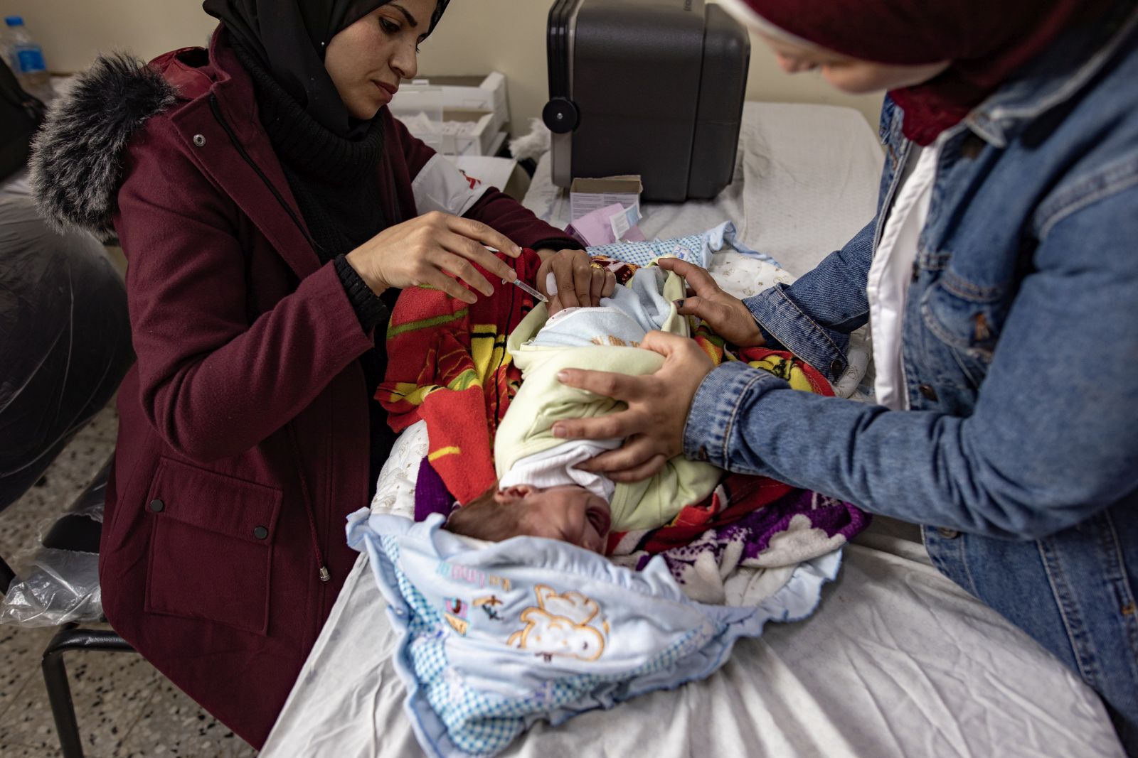 epa11149747 Members of the Spanish branch of Médecins Sans Frontières provide health care and vaccinations to displaced people in the Rafah camp in the southern Gaza Strip, 13 February 2024. Since 07 October 2023, up to 1.9 million people, or more than 85 percent of the population, have been displaced throughout the Gaza Strip, some more than once, according to the United Nations Relief and Works Agency for Palestine Refugees in the Near East (UNRWA), which added that most civilians in Gaza are in 'desperate need of humanitarian assistance and protection'.  EPA/HAITHAM IMAD