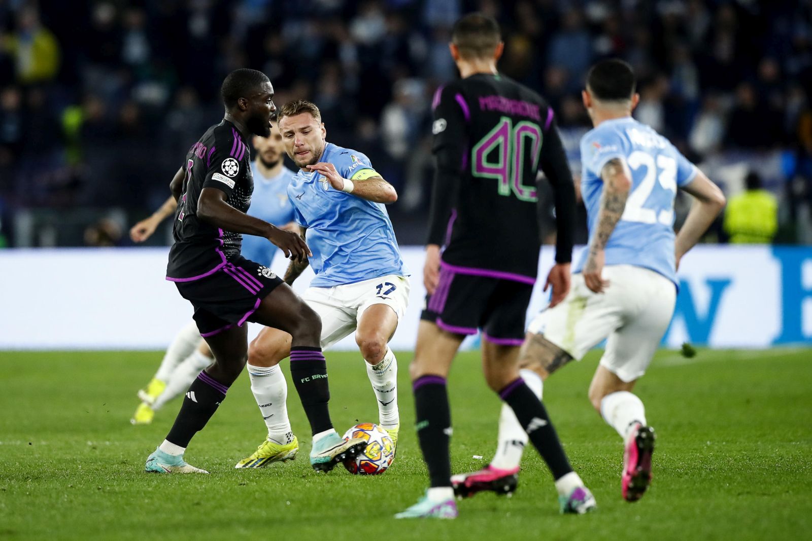 epa11153592 Bayern's Dayot Upamecano (L) and Lazio's Ciro Immobile (C) in action during the UEFA Champions League Round of 16, 1st leg soccer match SS Lazio vs FC Bayern Munich in Rome, Italy, 14 February 2024.  EPA/ANGELO CARCONI
