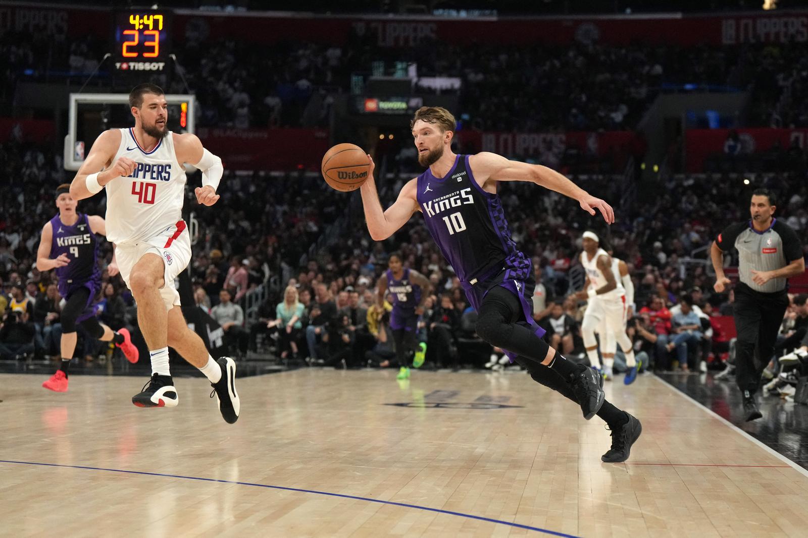 Feb 25, 2024; Los Angeles, California, USA; Sacramento Kings forward Domantas Sabonis (10) dribbles the ball against LA Clippers center Ivica Zubac (40) in the second half at Crypto.com Arena. Mandatory Credit: Kirby Lee-USA TODAY Sports Photo: Kirby Lee/REUTERS