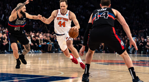 New York Knicks' Bojan Bogdanovic (44) drives to the basket against Detroit Pistons' Evan Fournier during the first half of an NBA basketball game in New York, Monday, March 25, 2024. (AP Photo/Peter K. Afriyie)