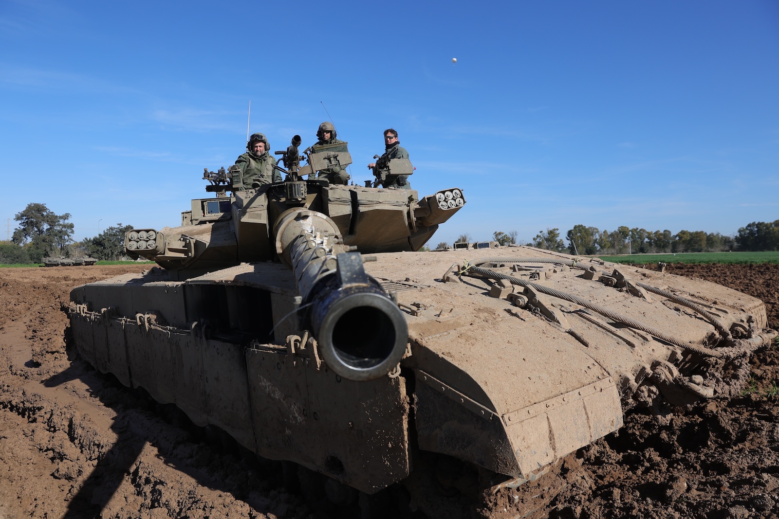 epa11135822 Israeli soldiers sit atop their tank near the Israeli border with Gaza Strip, at an undisclosed location in southern Israel, 08 February 2024. More than 27,500 Palestinians and over 1,300 Israelis have been killed, according to the Palestinian Health Ministry and the Israel Defense Forces (IDF), since Hamas militants launched an attack against Israel from the Gaza Strip on 07 October 2023, and the Israeli operations in Gaza and the West Bank which followed it.  EPA/ABIR SULTAN