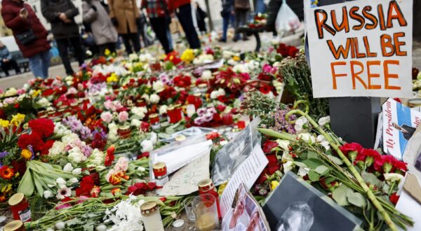 epa11170435 A photo showing late Russian opposition leader Alexei Navalny sits among floral tributes outside the Russian embassy in Berlin, Germany, 21 February 2024. Outspoken Kremlin critic Alexei Navalny died in a penal colony, the Federal Penitentiary Service of the Yamalo-Nenets Autonomous District announced on 16 February 2024. In late 2023 Navalny was transferred to an Arctic penal colony, considered one of the harshest prisons.  EPA/HANNIBAL HANSCHKE