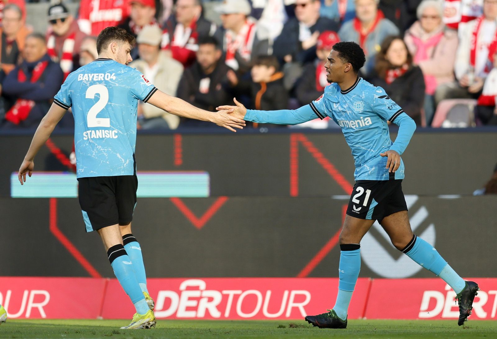 epa11196757 Leverkusen's Amine Adli (R) celebrates with teammate Josip Stanisic after his assist for the 2-0 lead during the German Bundesliga soccer match between 1. FC Cologne and Bayer 04 Leverkusen in Cologne, Germany, 03 March 2024.  EPA/RONALD WITTEK CONDITIONS - ATTENTION: The DFL regulations prohibit any use of photographs as image sequences and/or quasi-video.