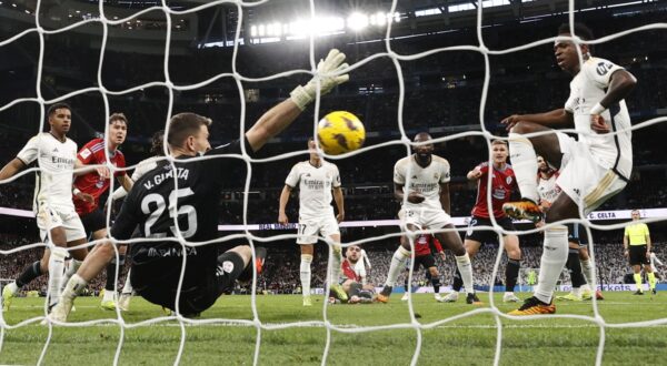 epa11211919 Real Madrid's Vinicius Jr. (R) scores the 1-0 goal during the Spanish LaLiga soccer match between Real Madrid and Celta de Vigo, in Madrid, Spain, 10 March 2024.  EPA/Chema Moya