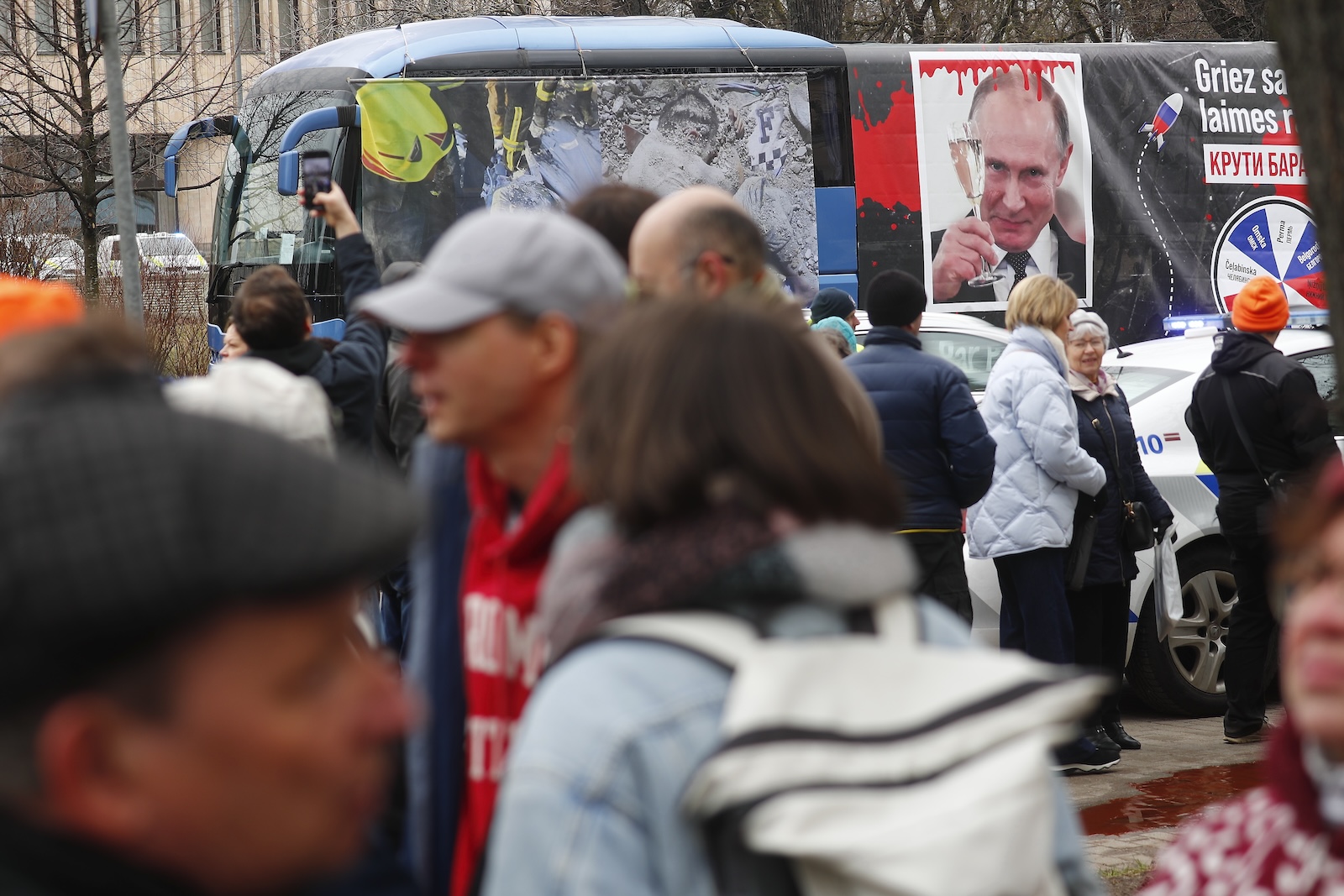 epa11226107 People protest against the Russian presidential elections and President Putin as Russian in Latvia wait in line on last day of voting in the Russian presidential election at the same embassy in Riga, Latvia, 17 March 2024. The Russian presidential election vote takes place between 15 and 17 March. Four candidates registered by the Central Election Commission of the Russian Federation are vying for the post of head of state: Leonid Slutsky, Nikolai Kharitonov, Vladislav Davankov and Vladimir Putin.  The team of late Russian opposition leader Alexei Navalny had called Russians to show their opposition to the elections and President Putin, by crowding voting centers on 17 March at midday. The protest was named 'Noon Against Putin'.  EPA/TOMS KALNINS