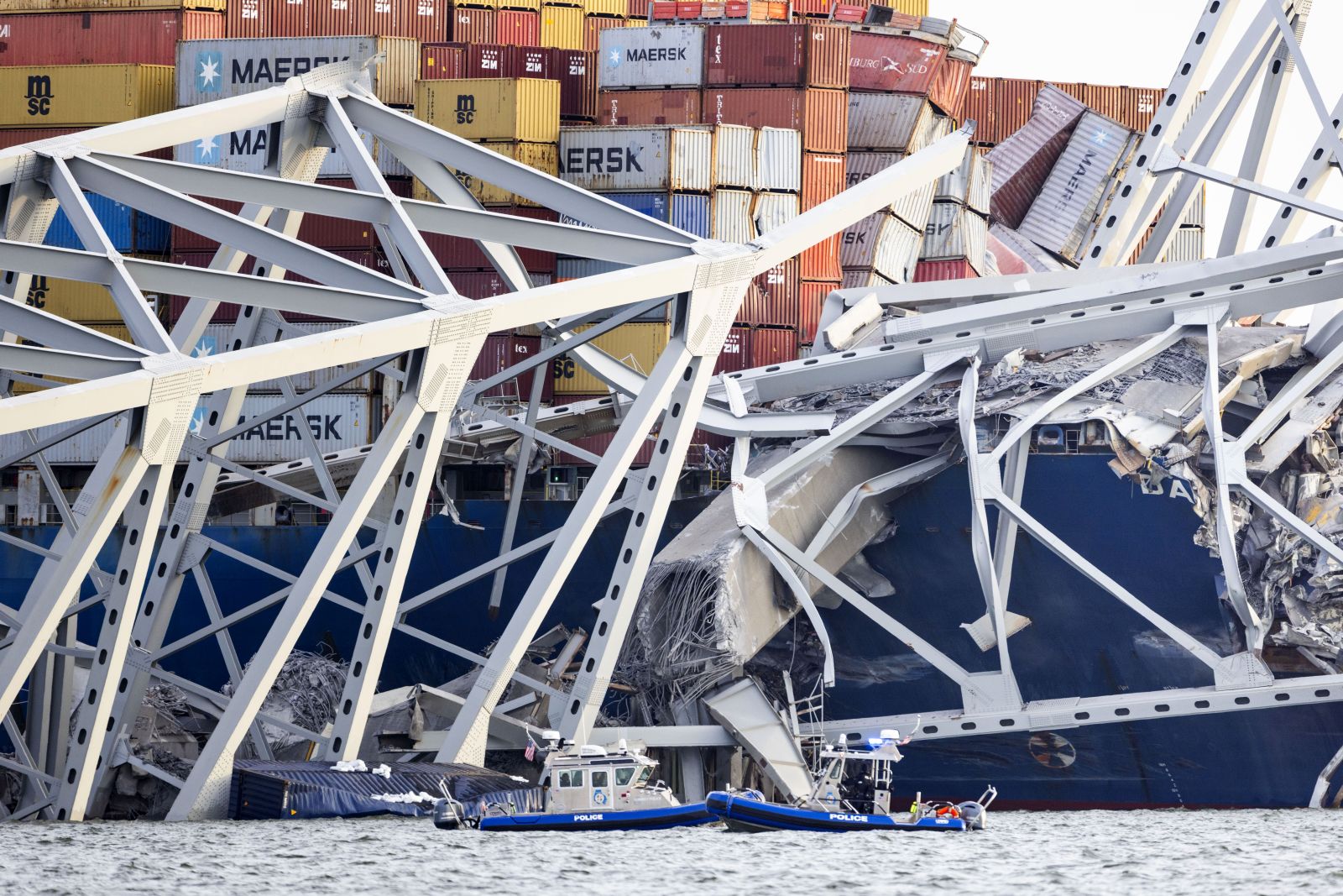 epa11244453 The Francis Scott Key Bridge rests partially collapsed after a cargo ship ran into it in Baltimore, Maryland, USA, 26 March 2024. The Maryland Department of Transportation confirmed that the Francis Scott Key Bridge collapsed due to a ship strike on 26 March. According to Baltimore City Fire Department Chief James W. Wallace, a search operation was underway to locate at least seven people believed to be in the waters of the Patapsco River following the incident. 'Sonar has detected the presence of vehicles submerged in the water', Wallace added. The Singapore-flagged cargo ship DALI was traveling from Baltimore to Colombo, Sri Lanka, MarineTraffic confirmed.  EPA/JIM LO SCALZO