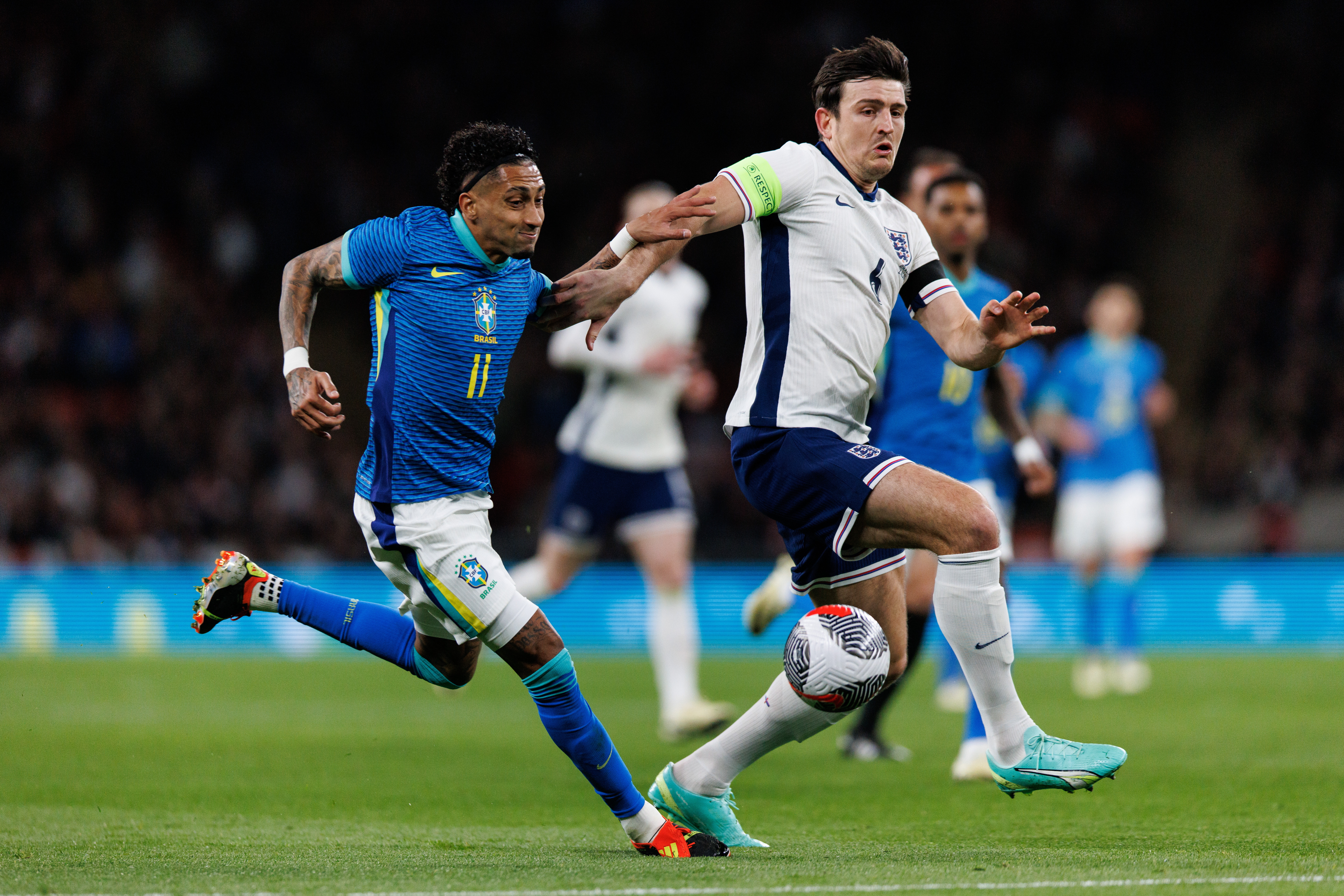 epa11239774 Harry Maguire of England in action against Raphinha of Brazil during the friendly international soccer match between England and Brazil in London, Britain, 23 March 2024.  EPA/TOLGA AKMEN