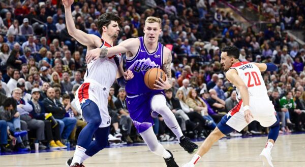 Mar 4, 2024; Salt Lake City, Utah, USA; Utah Jazz forward Luka Samanic (19) drives between Washington Wizards forward Deni Avdija (8) and guard Landry Shamet (20) during the second half at the Delta Center. Mandatory Credit: Christopher Creveling-USA TODAY Sports Photo: Christopher Creveling/REUTERS